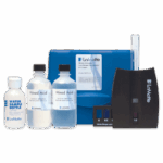 A Nitrate-Nitrogen Test Kit - 3615-01 featuring bottles labeled “Water Sample Bottle” and “Mixed Acid,” a test tube, color comparator, blue carrying case, and a small black stand with the LaMotte logo, all arranged on a white surface.