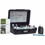 The Fresh Water Aquaculture Outfit Model AQ-2 - 3633-05 is a test kit in a black carrying case with reagent bottles, a test tube, a guide booklet, and a color comparator neatly arranged on a white surface.