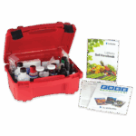 A red plastic case with Soil pH Test Kit - 5023 supplies, including bottles and droppers, sits open beside a soil handbook and informational pamphlets on a white background.