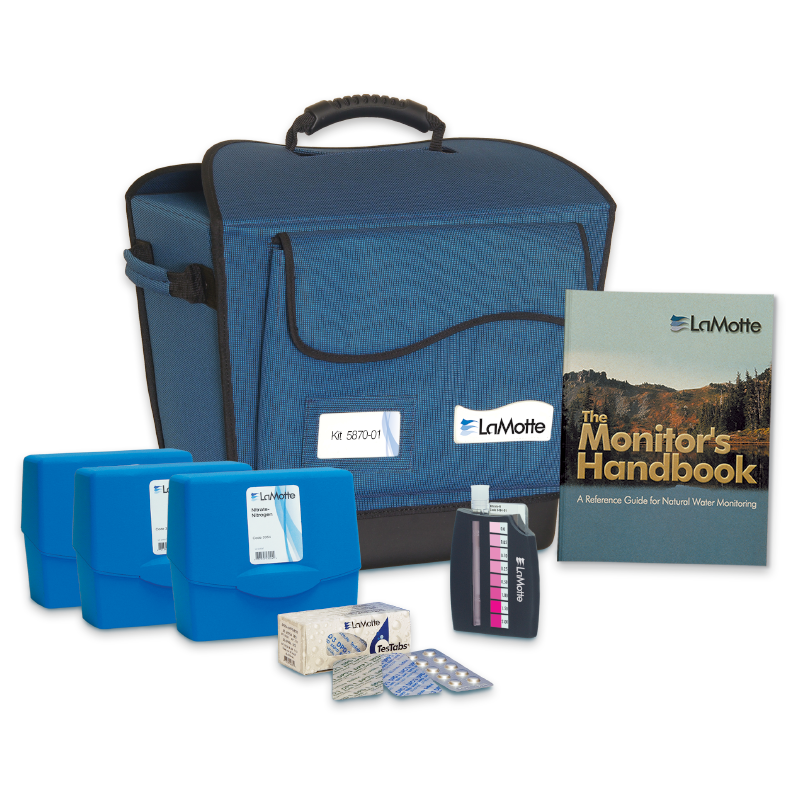 Blue carrying case, three blue plastic boxes, a color test block, small packets, tablets, and The Monitors Handbook displayed together—all part of the LaMotte Water Quality Educator and Monitoring Outfit - 5870-01.