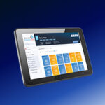 A tablet displaying a dashboard with blue and orange tiles and a navigation menu on the left, set against a blue gradient background.